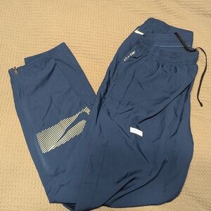 NWOT Nike Men's Blue Dri-Fit Sweatpants with Elastic Waistband and Tapered Ankle